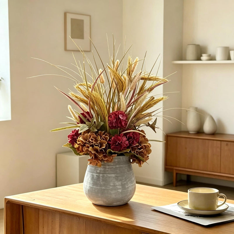 Artificial Fall Floral Centerpiece - Tonal Burgundy & Bronze Hydrangeas with Tall Grasses in Rustic Stone Vase